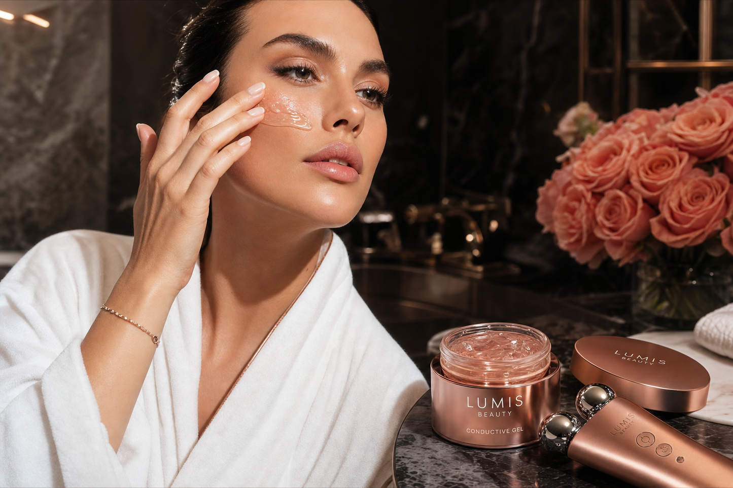 Lumis Conductive Gel accessory in a clear container, shown in a lifestyle setting with skincare tools and a woman using a device.